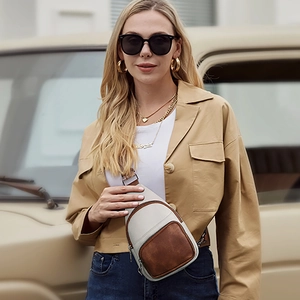 Fashionable PU leather crossbody chest bag in beige and brown shown on a female model