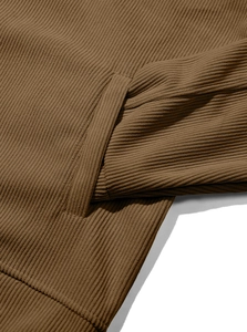Close-up detail of corduroy shirt pocket stitching and ribbed fabric texture in brown