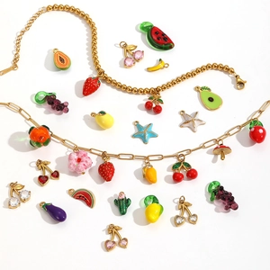 Golden bracelets with colorful enamel fruit pendants like strawberry and cherry on white background