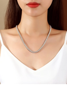 Detailed view of a 2mm S925 sterling silver tennis necklace with white zircon on a model