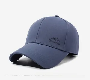 Side view of dark blue cotton twill baseball cap with mountain embroidery and curved brim