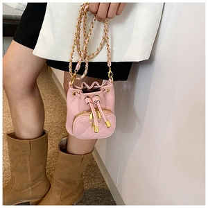 Pink drawstring bucket bag with quilted pocket and gold chain strap shown on a model