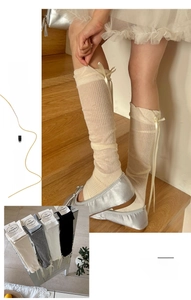Detail view of ballet style ribbed calf socks featuring silk ribbon bows in multiple colors