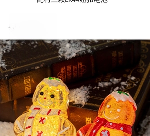 Close-up of glowing gingerbread man ornament with LR44 battery and warm LED lighting