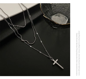 Detail view of silver triple-layered tarnish-free titanium steel necklace with cross pendant