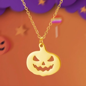 Close-up of golden hollow pumpkin pendant necklace with a festive Halloween theme