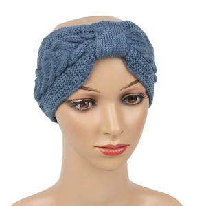 Detail of cable knit headband in dusty blue with soft woolen texture and bow design