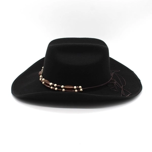 Detail of black wool felt cowboy hat with double-layered beadwork and woven knot accents
