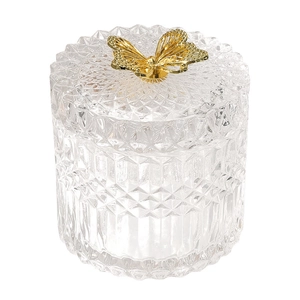 Vintage relief glass storage jar with a gold butterfly lid on a pure white background
