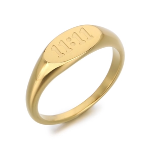 Gold titanium steel signet ring with engraved 11:11 angel number on oval face.