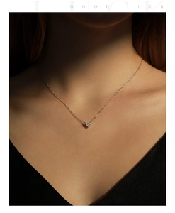 Close-up of a delicate S925 sterling silver heart pendant necklace with shimmering crystals