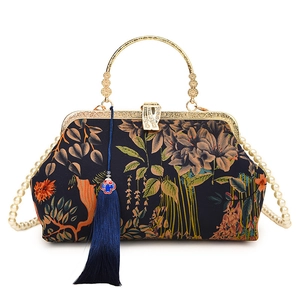 Vintage Chinese style floral handbag with pearl chain and tassel on white background