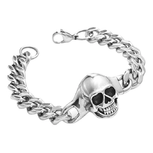 Close-up of punk style silver skull bracelet with chunky Cuban chain and polished metal finish