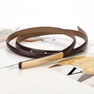 Elegant thin dark brown leather waist belt for women with a sleek gold metal buckle