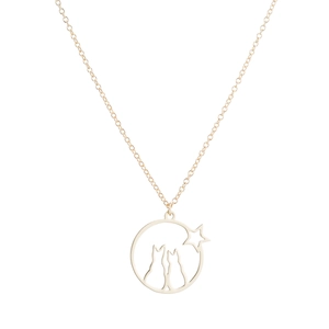 Detailed close-up of a gold-plated circular pendant with two cats and star silhouettes
