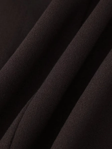 Close-up macro view of thick dark wool blend fabric texture on long coat garment