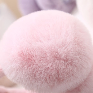 Detailed close-up of premium soft pink faux fur material on foldable earmuffs