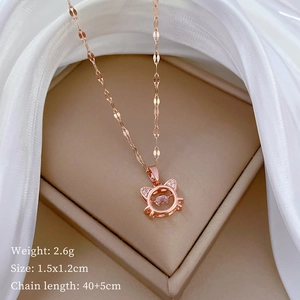 Close-up of a rose gold cat pendant with a suspended diamond and product specifications