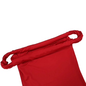 Close-up of the red off-shoulder dress featuring a unique twisted knot shoulder strap detail