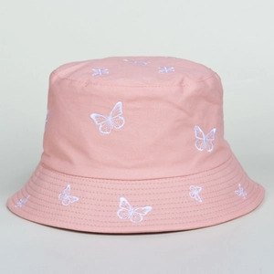 Close-up of white butterfly embroidery details on the pink cotton bucket hat