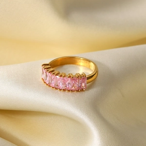 Macro shot of 18K gold-plated band ring with emerald-cut pink cubic zirconia stones