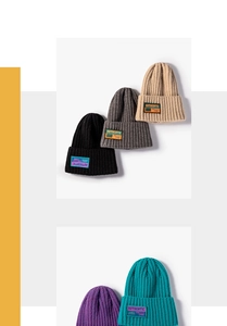 Detail showing various colors of ribbed knit beanies with authentic cloth labels