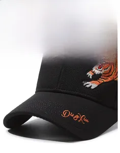 Detail of high-density tiger embroidery and orange Ding Xin lettering on black canvas cap
