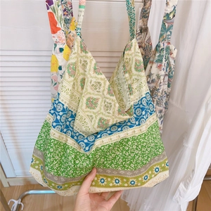 Detail of artistic cotton tote bags with vintage floral and striped prints on display