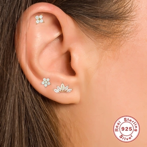 Macro shot of sterling silver stud earrings with zirconia on ear lobe detail