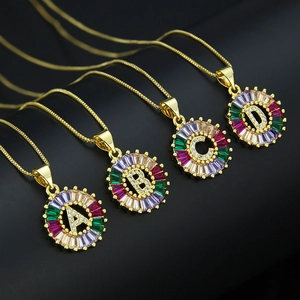 Detail of colorful rainbow zircon initial pendants A-D on gold plated necklaces