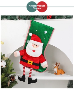 Detail of green velvet Christmas stocking with 3D Santa Claus and striped trim