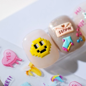 3D pixel art nail stickers featuring yellow smiley faces, pink hearts, and retro icons