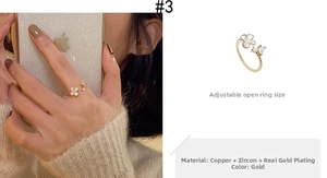 Detail of adjustable flower-shaped gold ring with water drop zircon petals and copper base