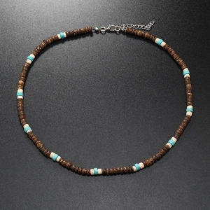 Detail of beaded necklace with coconut shell, turquoise beads and silver lobster clasp