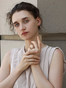 Detailed view of 18K gold plated layered ring set with imitation pearls on female model