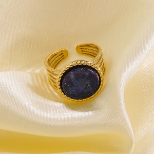 Detail of vintage 14K gold open ring with natural blue lapis lazuli on silk background