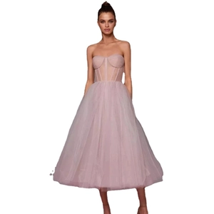 Elegant strapless tulle party dress in light pink with corset bodice and tiered mesh skirt