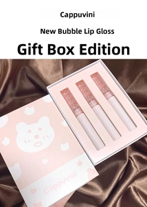 Three-piece mirror water glow lip glaze set with cute bear packaging on velvet surface