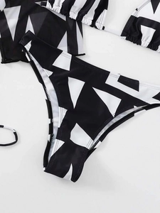 Detailed view of high-cut bikini bottoms with black and white geometric pattern print