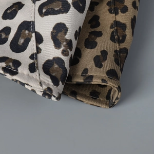 Macro view of twill leopard print fabric showing high-quality stitching and texture