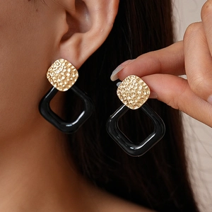 Modern geometric square drop earrings with gold hammered metal and black resin rings