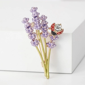 Elegant lavender brooch with purple enamel flowers and a red rhinestone ladybug ornament