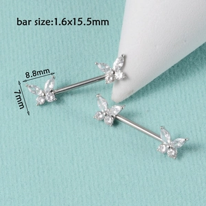 Macro view of silver stainless steel nipple rings with zircon butterfly ends and size info