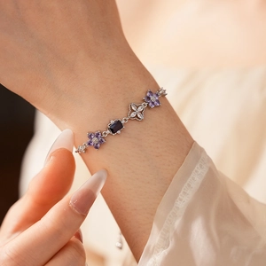 Detailed close-up of zircon flower bracelet with purple stones and adjustable chain