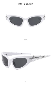 Detail view of white futuristic cat-eye sunglasses with star accents and black lenses