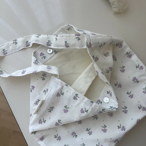 Detail view of cotton floral bag interior with magnetic clasp and Simple Wish label