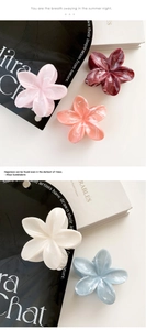 Detailed macro view of high-quality resin flower hair claws in multiple pastel colors