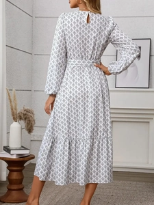 Elegant white long-sleeve floral maxi dress with black leaf print and belted back view