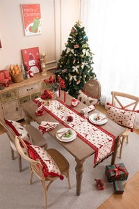 Christmas table runner and matching pillows with reindeer, snowflakes, and red tassels