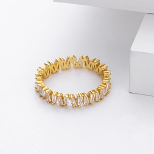 Detailed macro shot of a gold-plated V-shaped ring with pavé-set white zircon stones